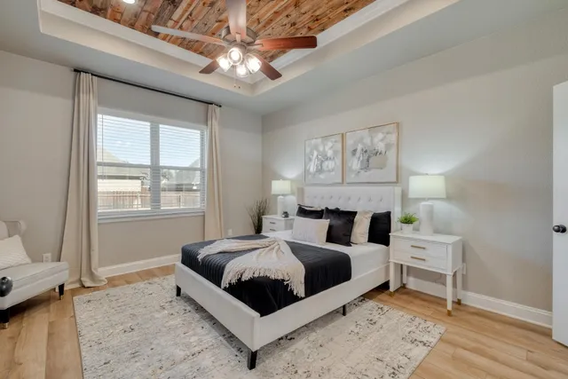 a bedroom with a large bed and a window