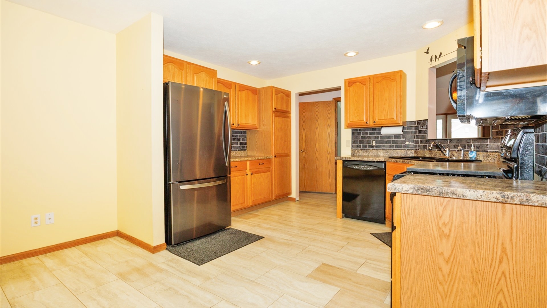 411 Wildberry Drive Normal, IL 61761 - Photo 15 of 51 a kitchen with stainless steel appliances granite countertop a refrigerator a stove and a sink