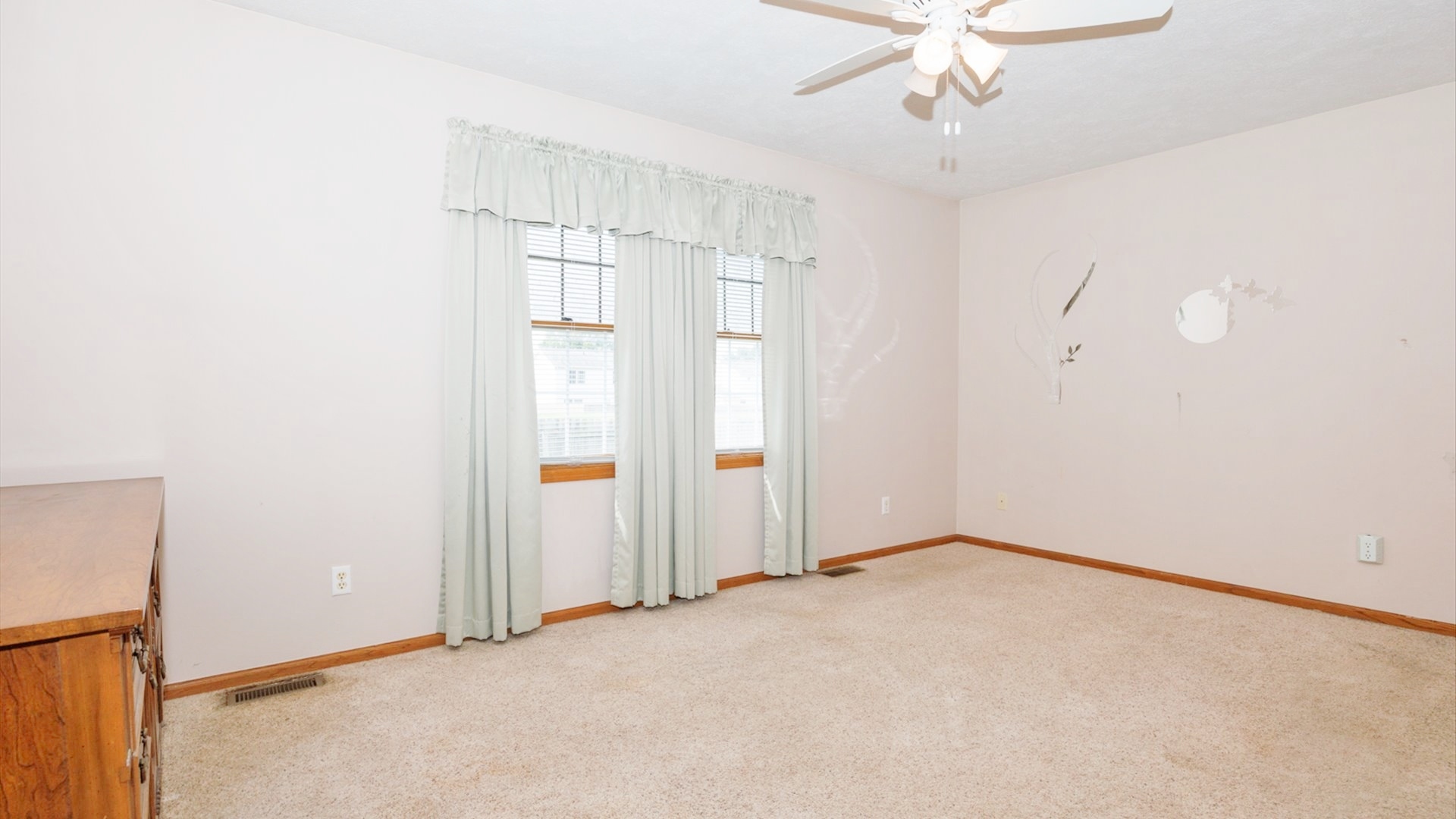 411 Wildberry Drive Normal, IL 61761 - Photo 20 of 51 an empty room with chandelier fan and windows