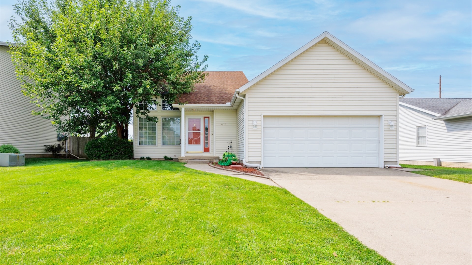 411 Wildberry Drive Normal, IL 61761 - Photo 2 of 51 a view of a house with a yard and garage