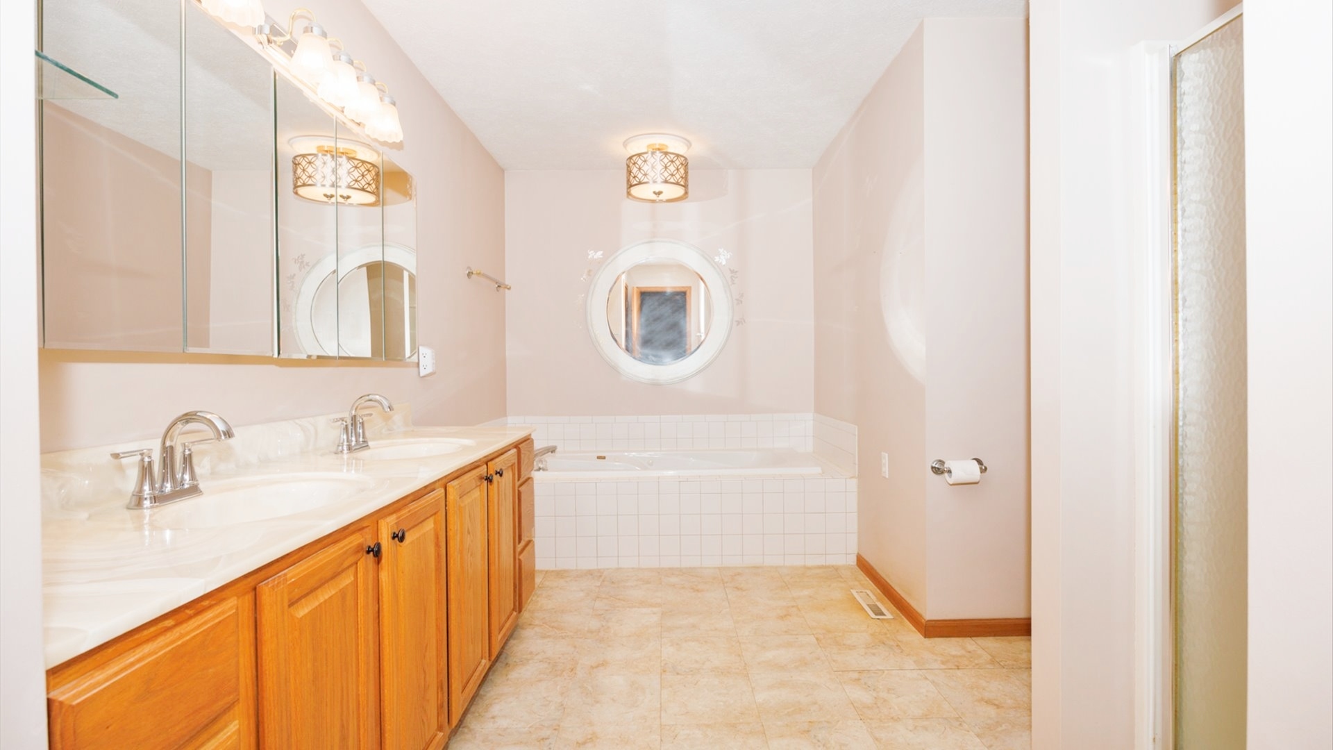 411 Wildberry Drive Normal, IL 61761 - Photo 25 of 51 a bathroom with a sink a mirror and a bathtub