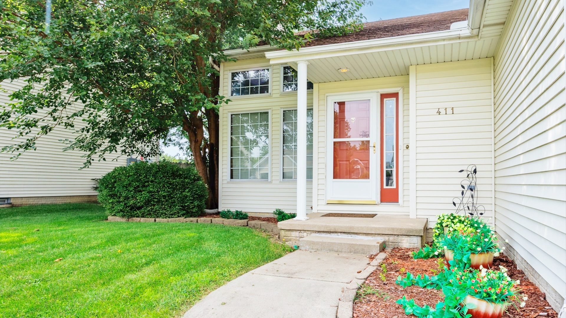 411 Wildberry Drive Normal, IL 61761 - Photo 48 of 51 a front view of a house with a garden