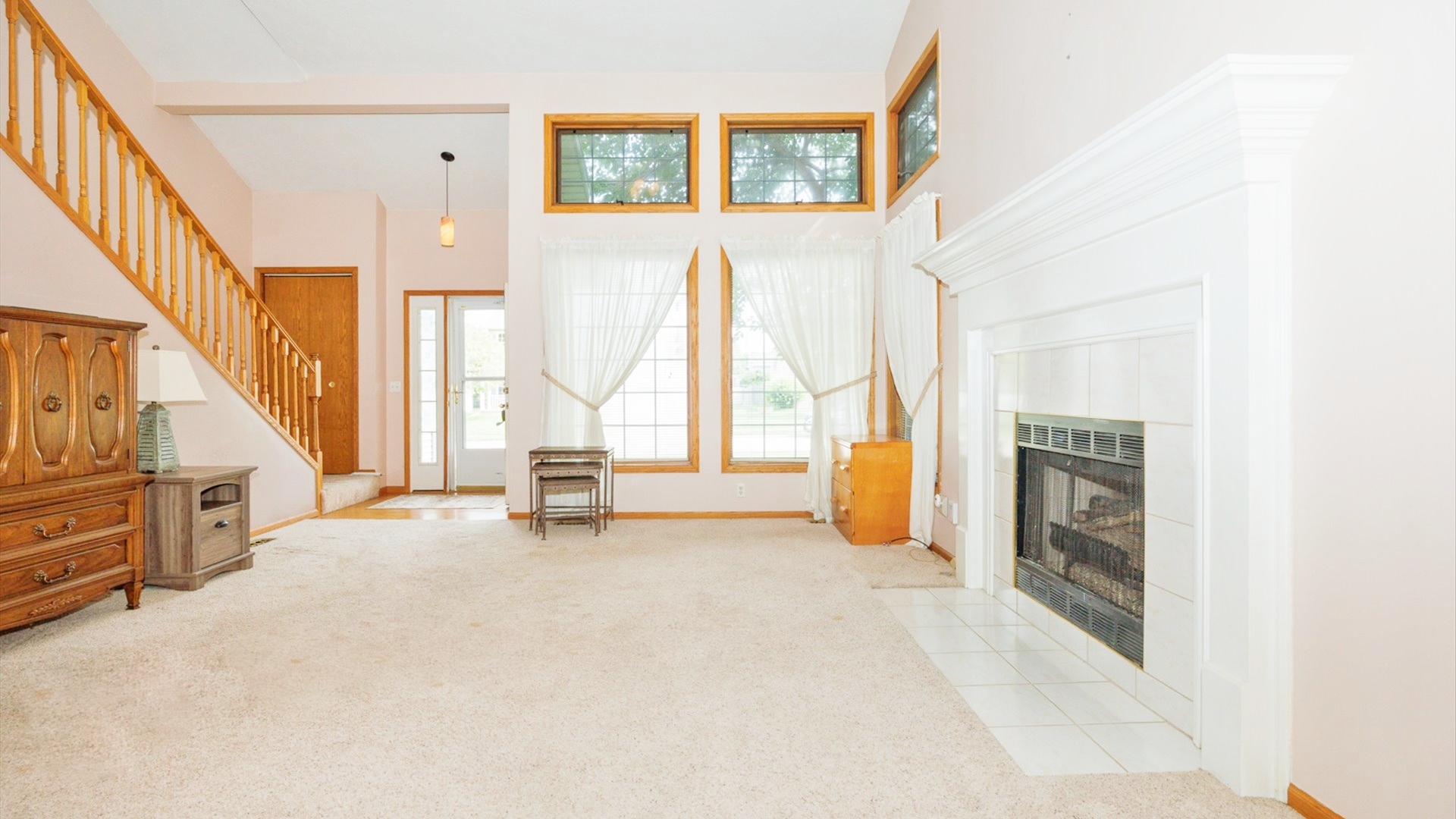 411 Wildberry Drive Normal, IL 61761 - Photo 8 of 51 a view of an empty room with a fireplace and windows
