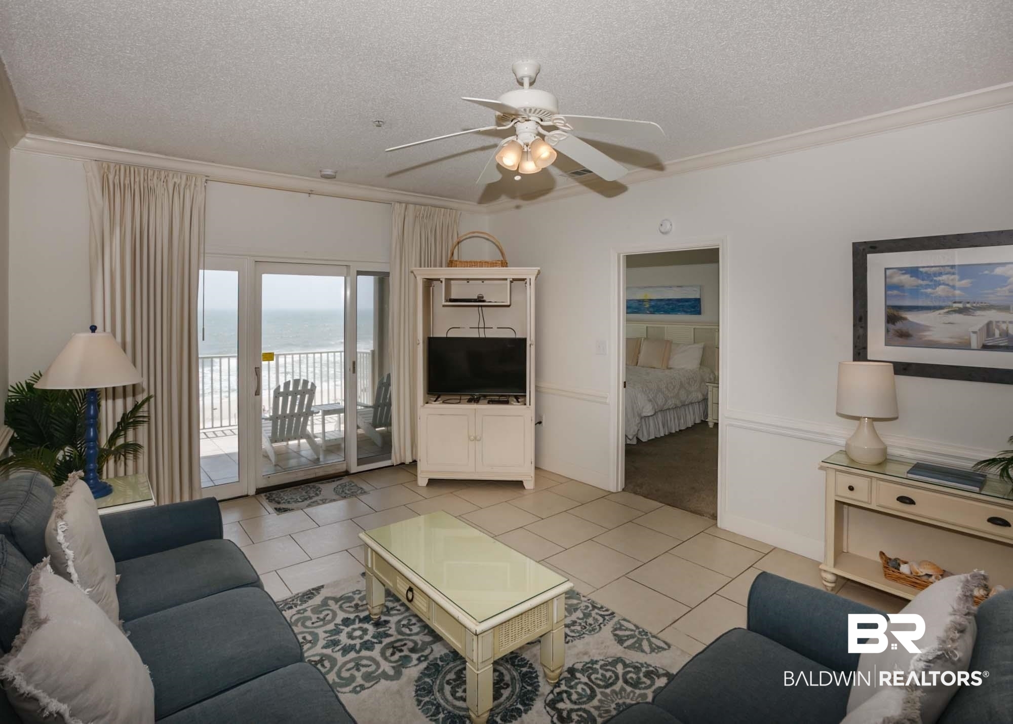 28910 Perdido Beach Boulevard, Unit 4B Orange Beach, AL 36561 - Photo 14 of 48 Living area featuring light tile patterned floors, a textured ceiling, crown molding, and ceiling fan