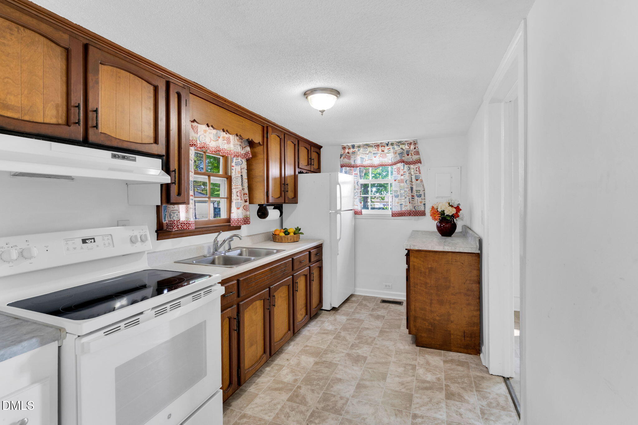 310 Chicopee Road Benson, NC 27504 - Photo 11 of 23 a kitchen that has a sink and a stove in it