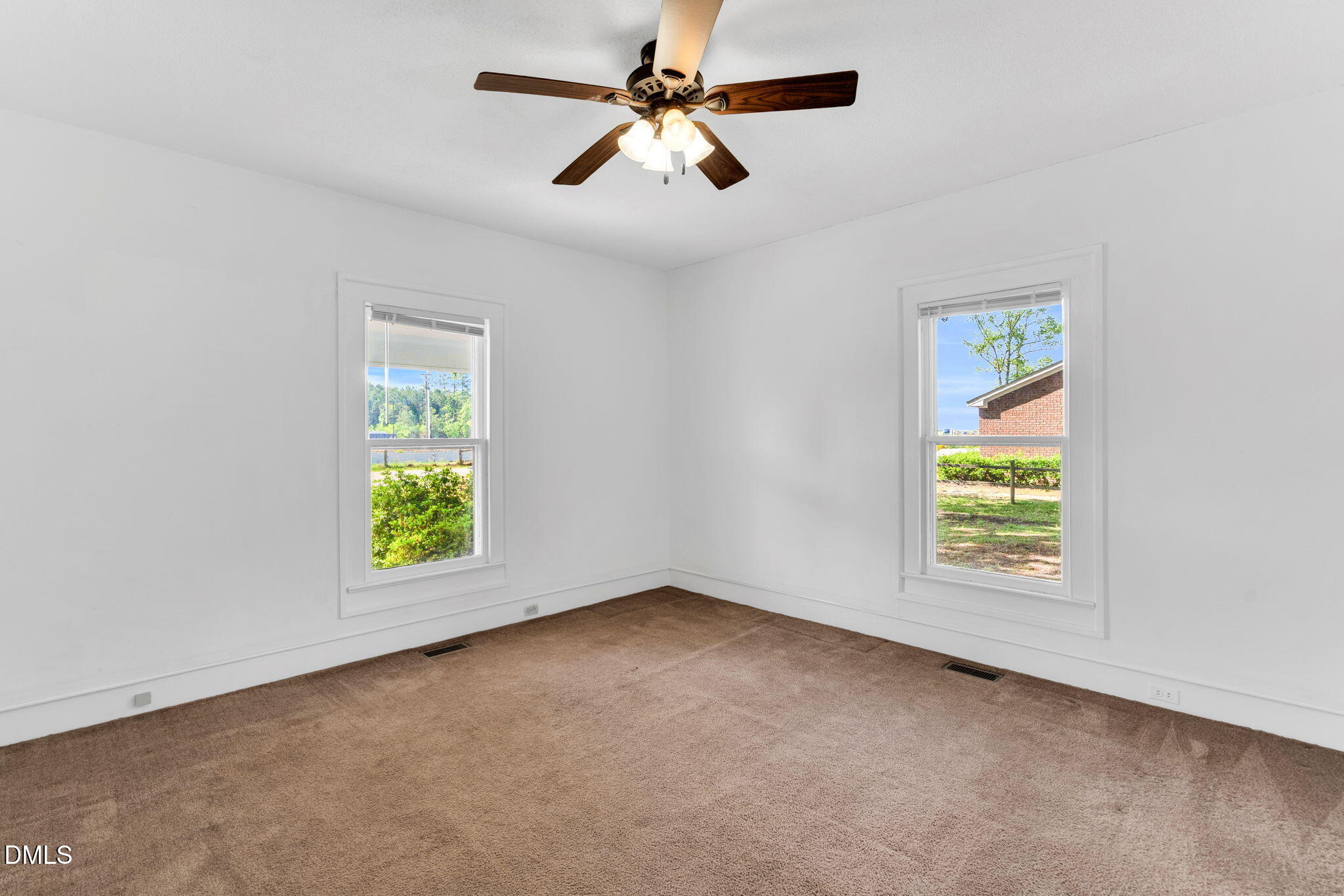 310 Chicopee Road Benson, NC 27504 - Photo 5 of 23 an empty room with window and fan