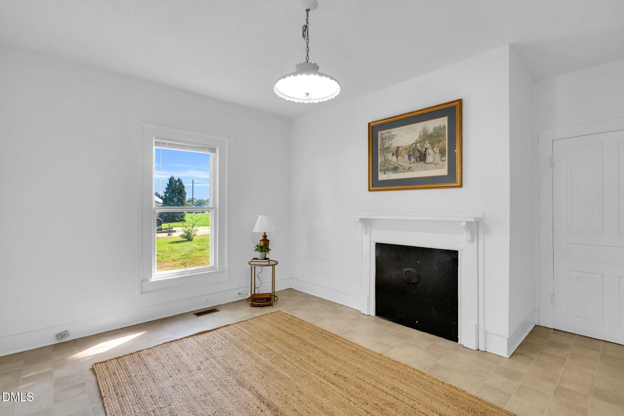 310 Chicopee Road Benson, NC 27504 - Photo 7 of 23 a view of an empty room with a window and fireplace