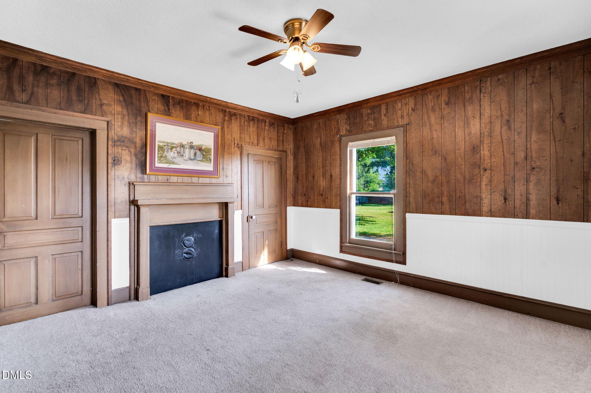 310 Chicopee Road Benson, NC 27504 - Photo 10 of 23 a view of an empty room with a fireplace and a window