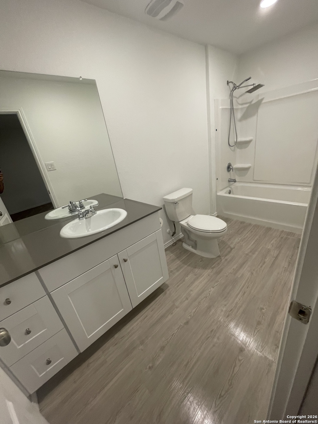 31885 Cherry Bulverde, TX 78163 - Photo 12 of 27 a bathroom with a granite countertop sink a toilet and a mirror