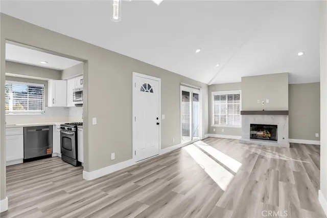 a view of livingroom with kitchen and fireplace