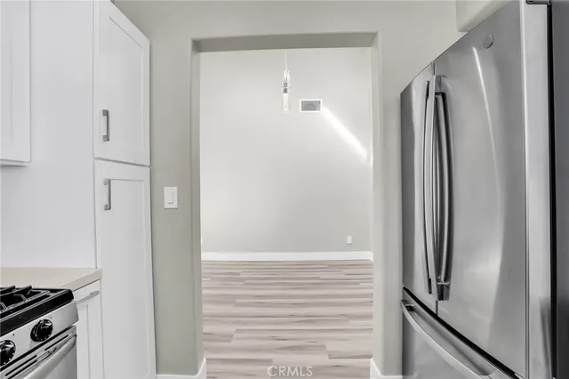 a view of kitchen cabinets and stainless steel appliances