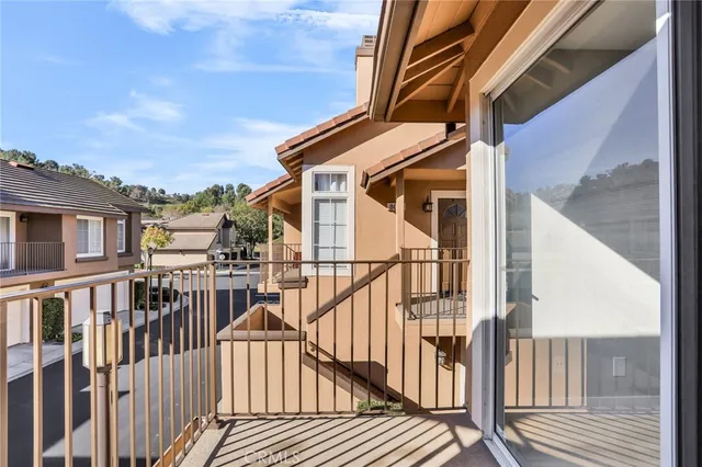 a view of a house with pool and wooden stairs