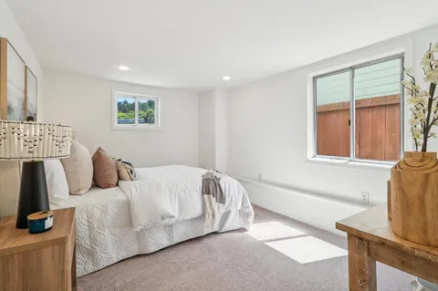 a bed room with a bed and a night stand