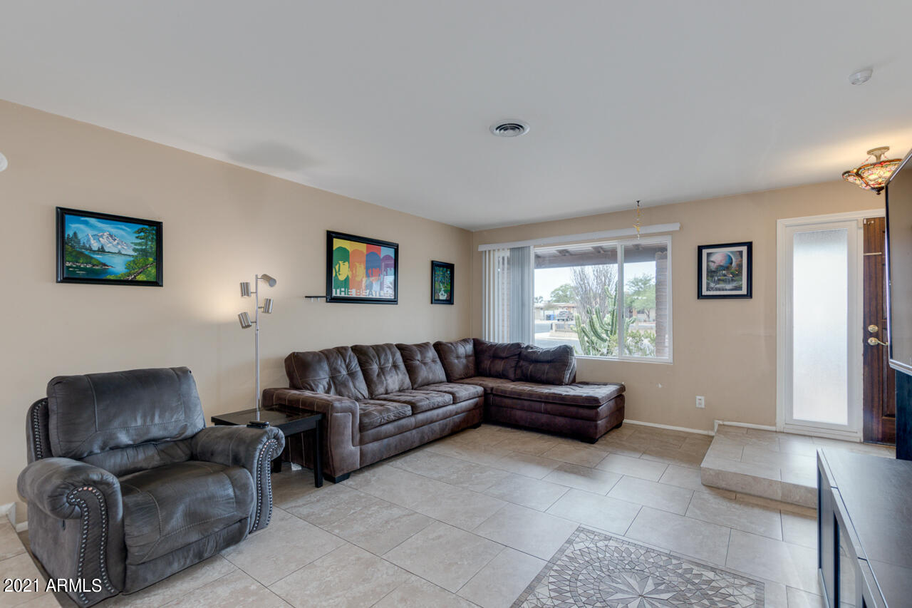 4215 West Dailey Street Phoenix, AZ 85053 - Photo 7 of 32 a living room with furniture and a window