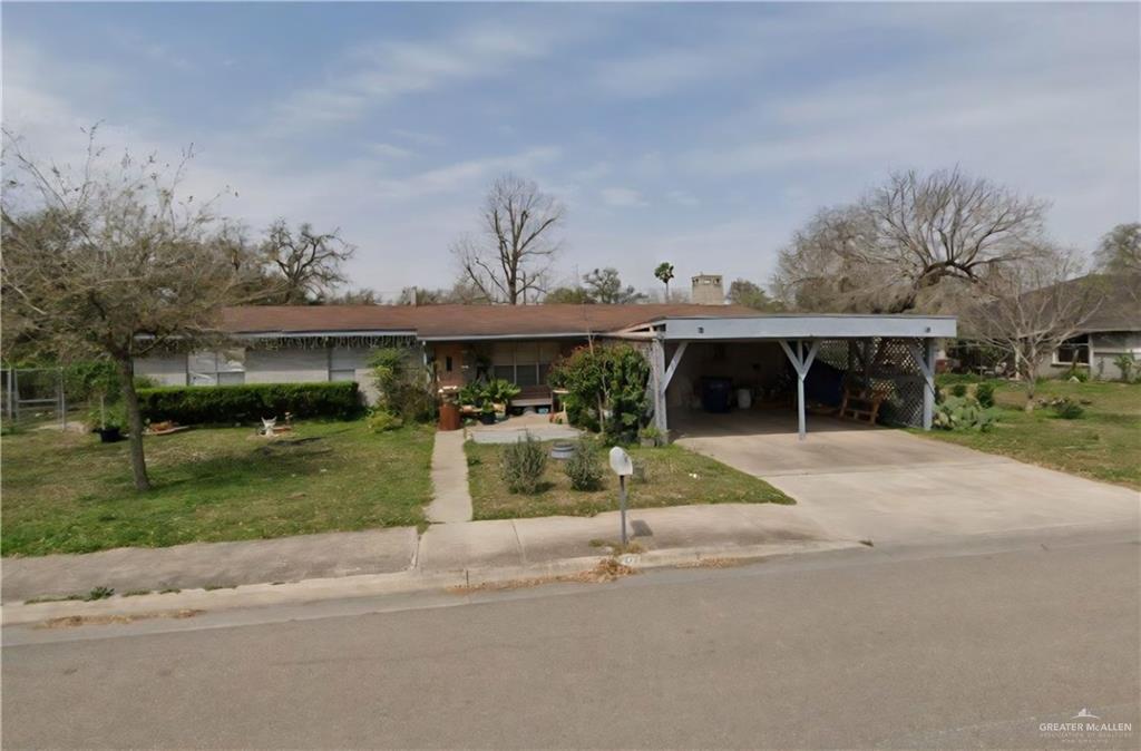 421 South Main Street Donna, TX 78537 - Photo 1 of 24 front view of house with a yard and potted plants