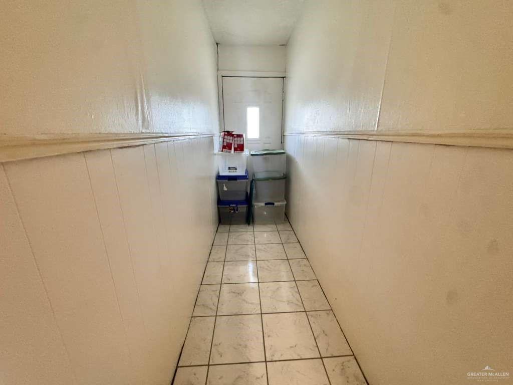 421 South Main Street Donna, TX 78537 - Photo 14 of 24 a bathroom with a refrigerator and a stove