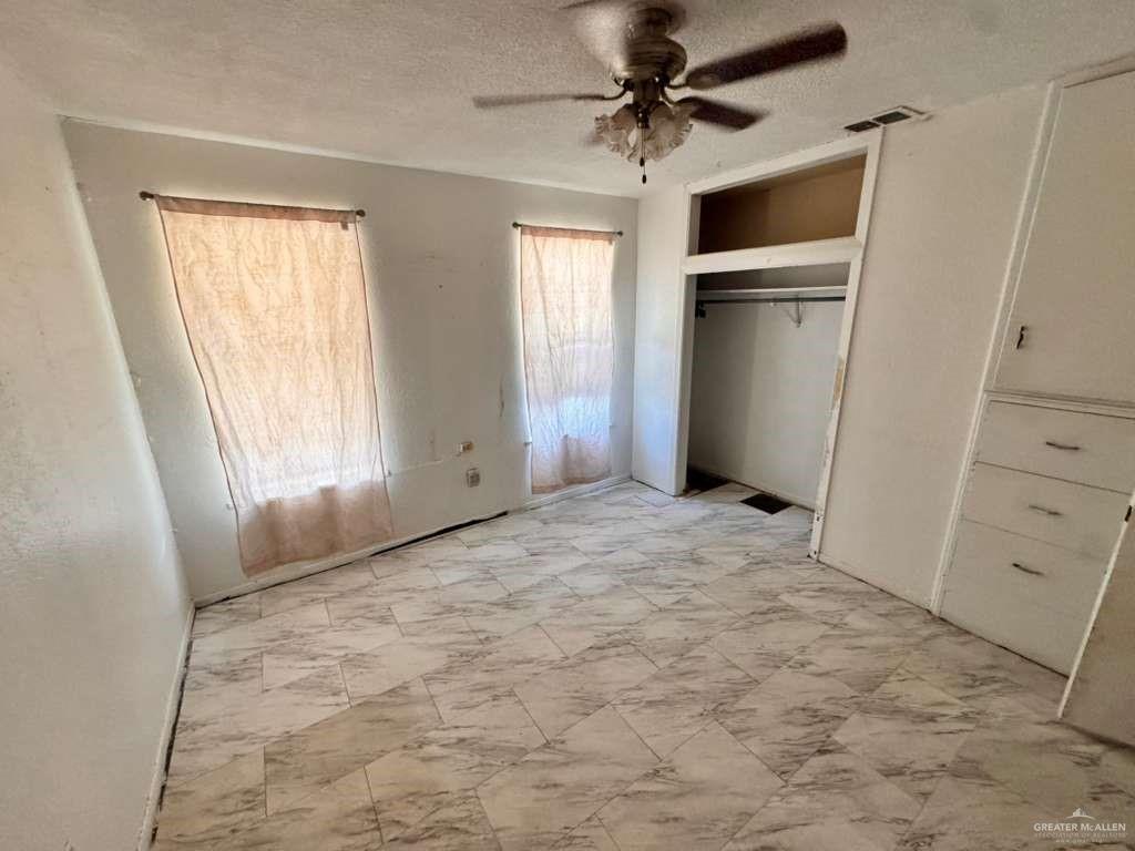 421 South Main Street Donna, TX 78537 - Photo 4 of 24 a view of empty room with window and ceiling fan