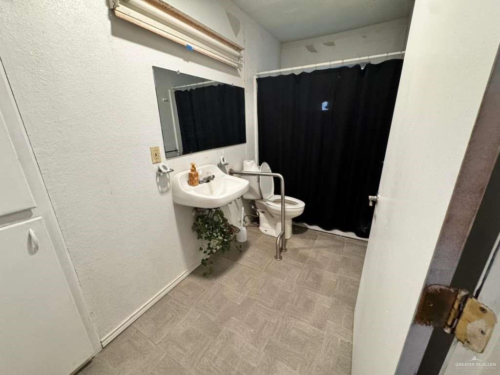 421 South Main Street Donna, TX 78537 - Photo 8 of 24 a bathroom with a sink toilet and mirror