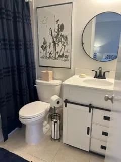 a bathroom with a sink toilet and a mirror