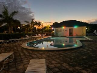 1605 Highway 1, Unit F204 Jupiter, FL 33477 - Photo 17 of 33 a view of a swimming pool with a yard