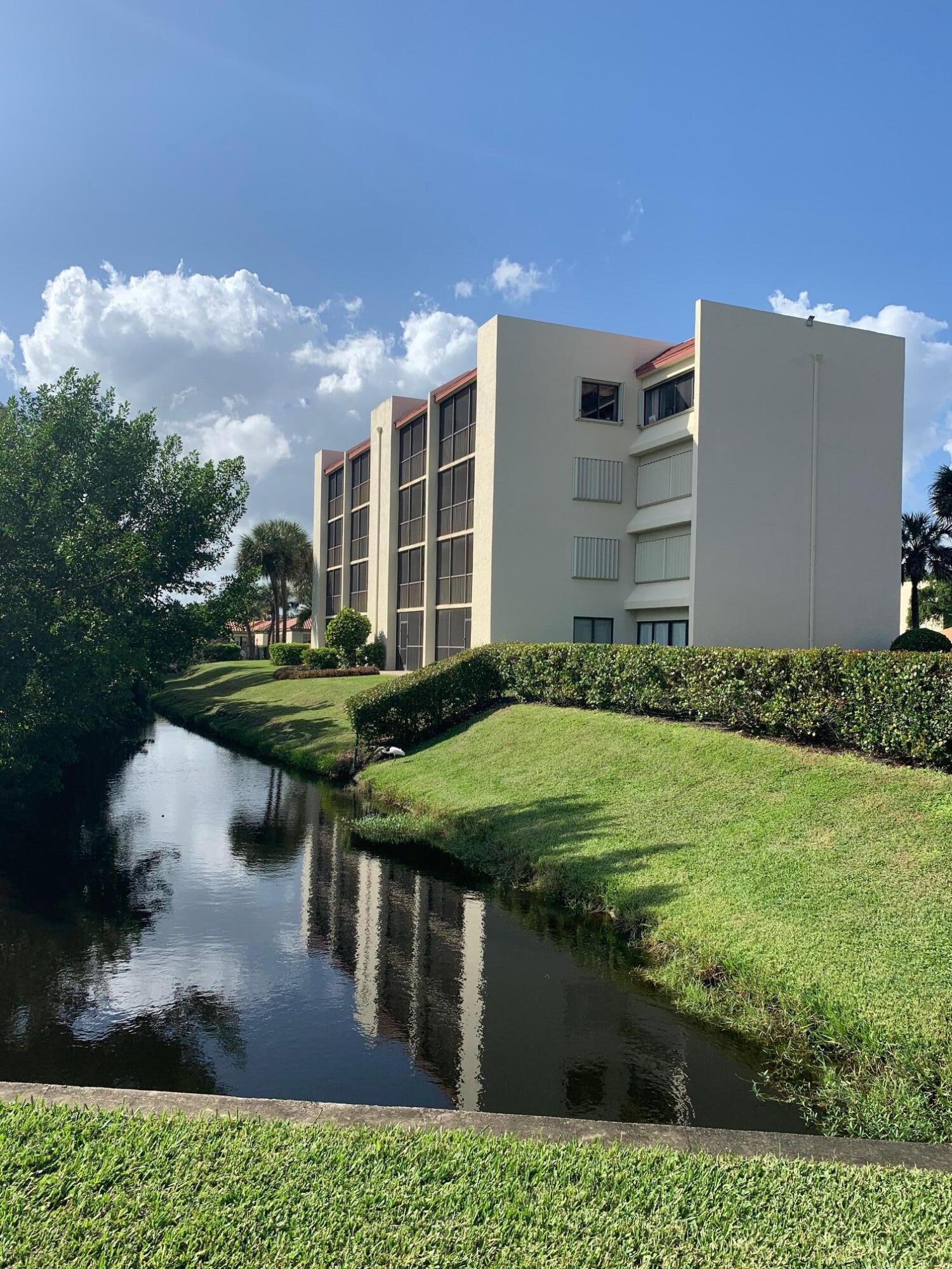 1605 Highway 1, Unit F204 Jupiter, FL 33477 - Photo 2 of 33 a swimming pool with outdoor seating and yard