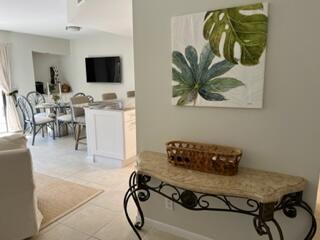 1605 Highway 1, Unit F204 Jupiter, FL 33477 - Photo 3 of 33 a living room with furniture and a flat screen tv