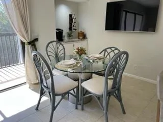 a dining room with furniture and wooden floor