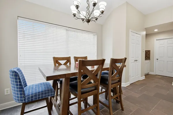 a view of a dining room with furniture and chandelier