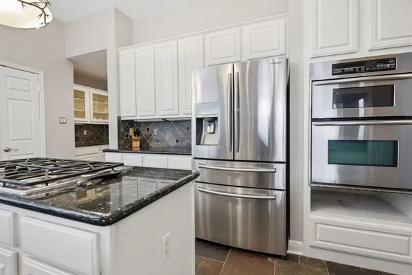 a kitchen with appliances a sink and cabinets