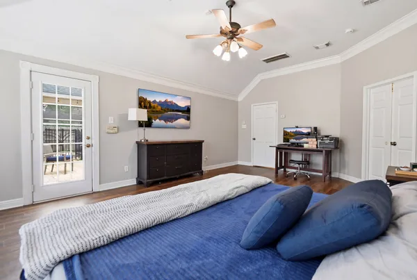 a bedroom with a large bed and a dresser