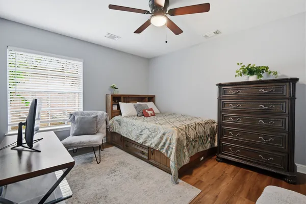 a bedroom with a bed and a chandelier
