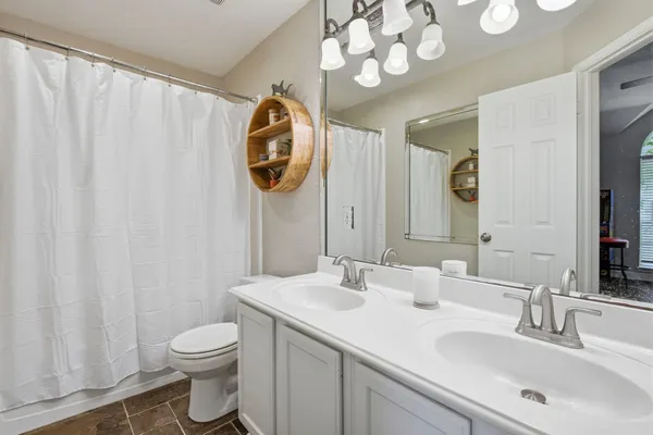 a bathroom with a sink toilet and a mirror