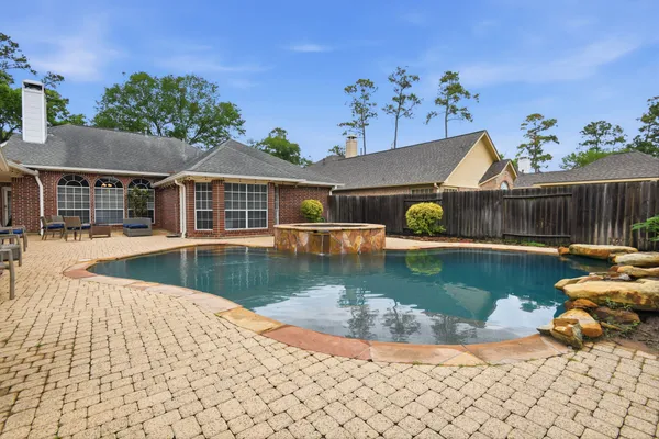 a view of a house with pool and a yard
