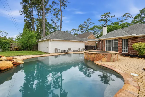 a house view with swimming pool and a yard