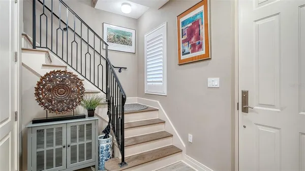 a view of staircase with wooden floor and white walls
