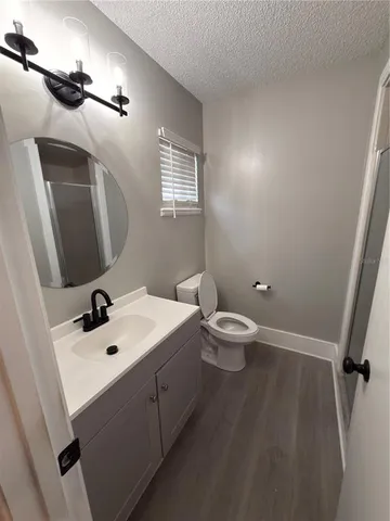 a bathroom with a sink a toilet and mirror