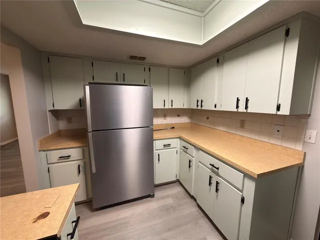 a kitchen with a refrigerator a stove top oven a sink and a refrigerator