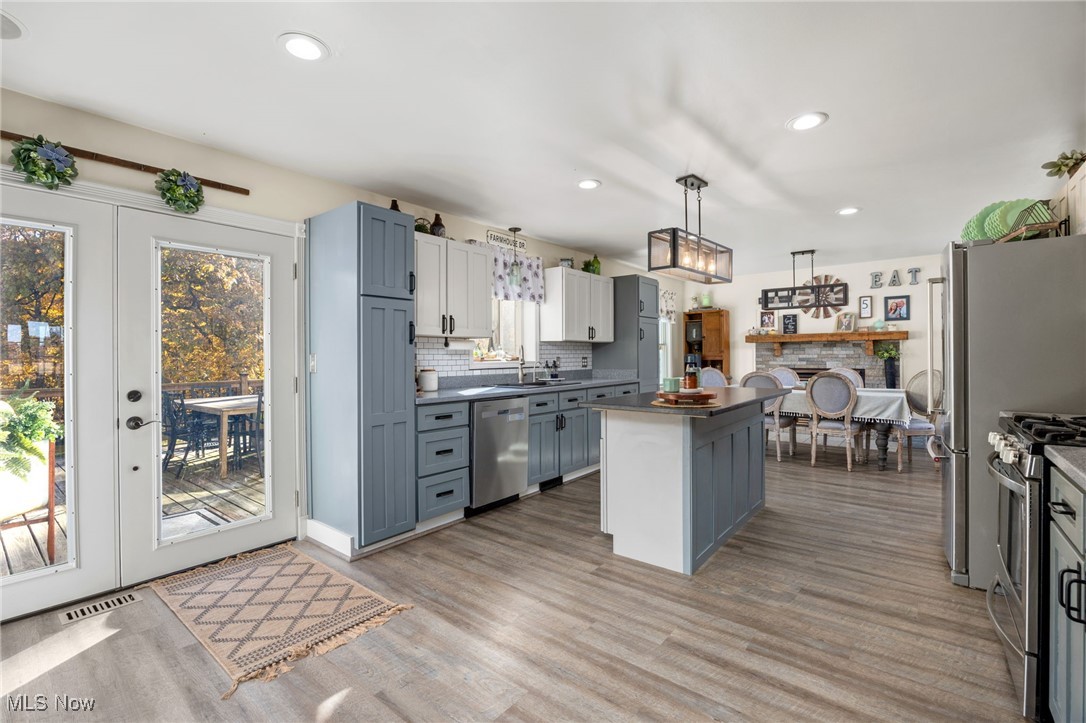 11827 Stratton Road West Salem, OH 44287 - Photo 20 of 47 Kitchen featuring gray cabinets, dark countertops, recessed lighting, french doors, and decorative backsplash