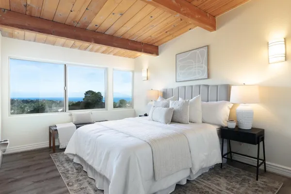 a bedroom with bed and a large window