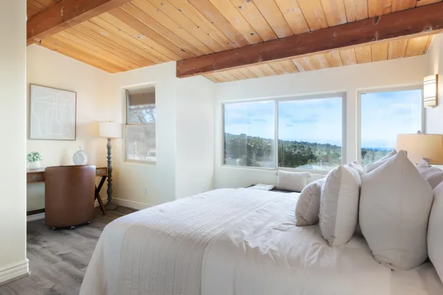 a bedroom with a bed and a chair