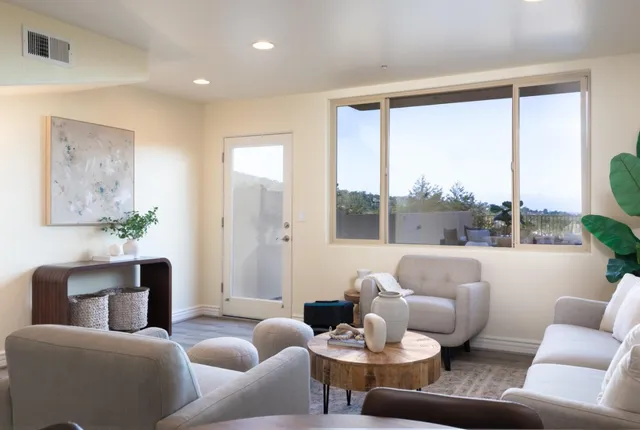 a living room with furniture and kitchen view