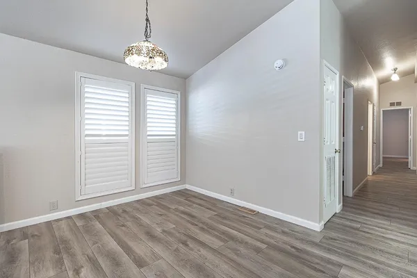 a view of a room with wooden floor and window