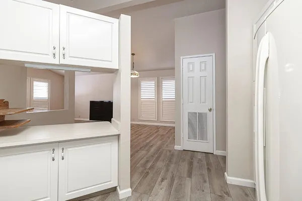 a kitchen with a sink dishwasher a stove and a refrigerator with wooden floor
