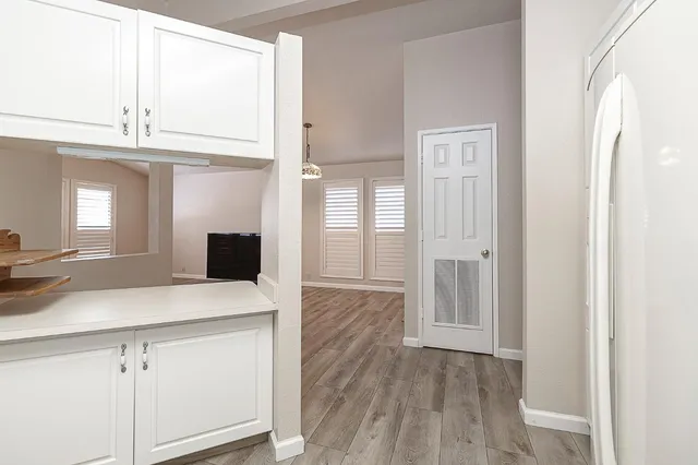 a kitchen with a sink dishwasher a stove and a refrigerator with wooden floor