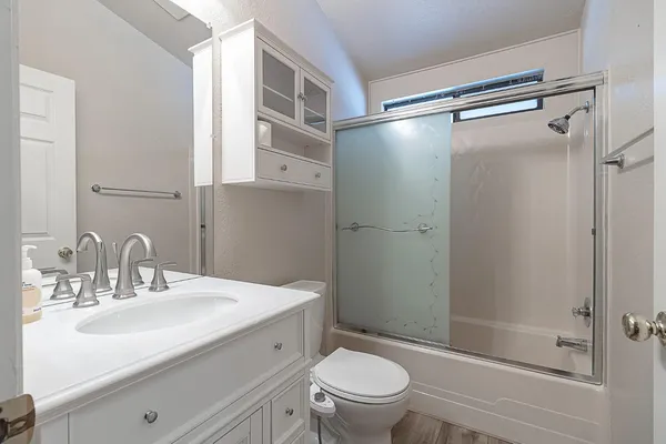 a bathroom with a sink toilet and shower