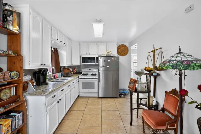 a kitchen with a sink appliances and cabinets