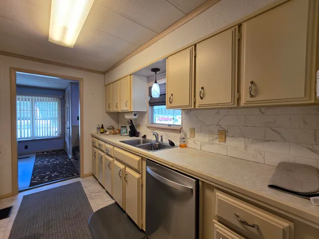 a kitchen with stainless steel appliances granite countertop a sink stove and cabinets