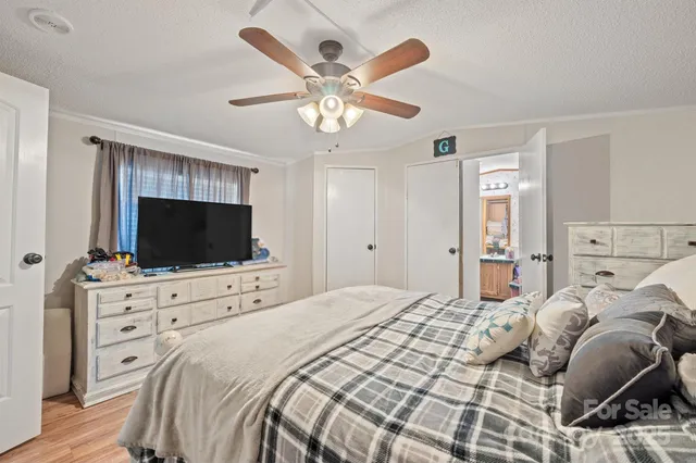 a living room with furniture a wooden floor and next to a window