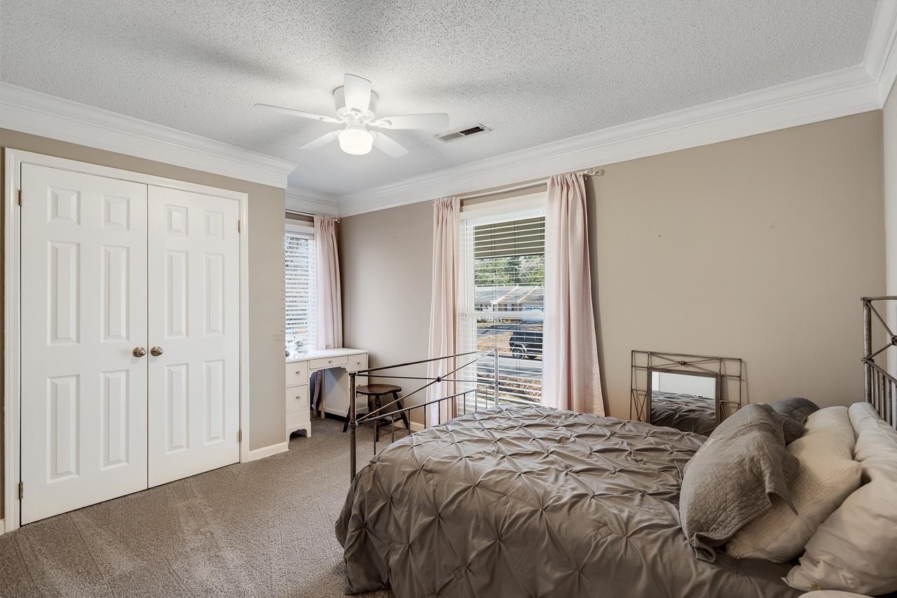 455 Burley Road Collierville, TN 38017 - Photo 20 of 25 a bedroom with a bed and a chandelier