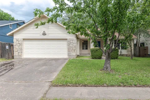 a front view of house with a yard and trees